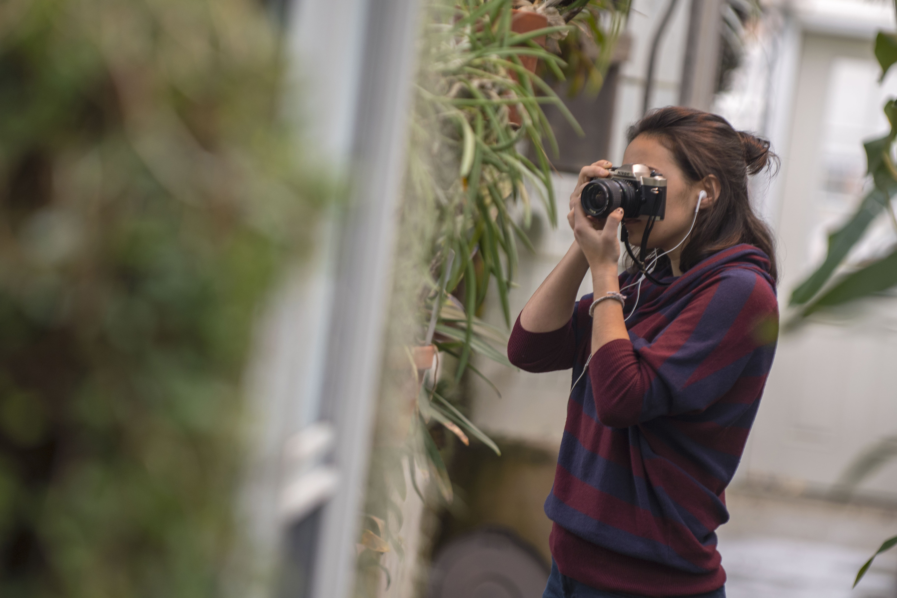 Marissa Aldieri '18 (CLAS), an individualized major, takes photos for Intermediate Photography taught by Kaleigh Rusgrove at the UConn Biodiversity Education and Research Greenhouses on Feb. 12, 2018. (Garrett Spahn '18 (CLAS)/UConn Photo)
