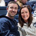 Ryan and Laura Marcoux attend a women's basketball game in Gampel Pavilion during their recent visit to Storrs. (Stephen Slade '89 (SFA) for UConn)