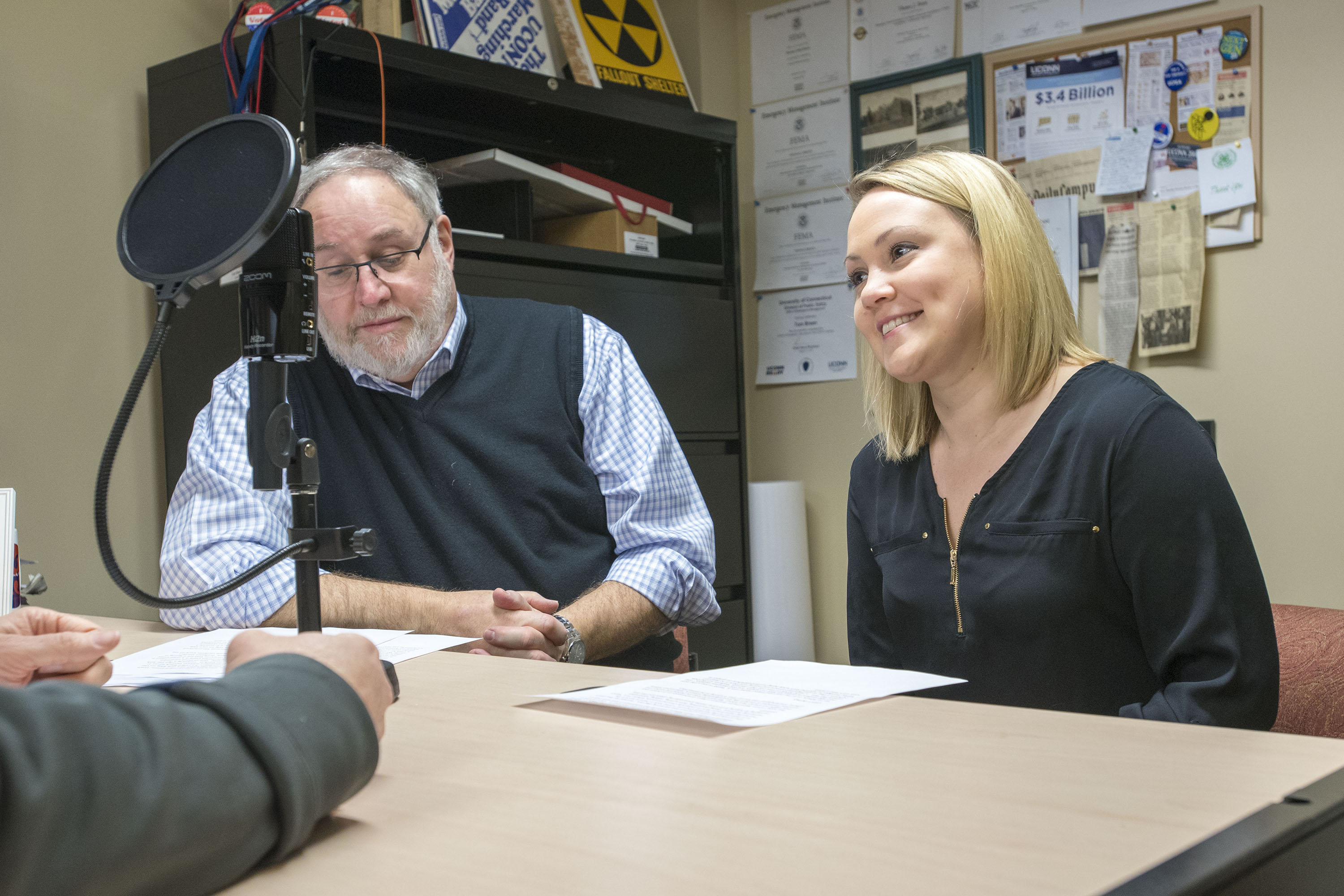 (left to right) Kenneth Best, and Julie (Stagis) Bartucca ’10 (BUS, CLAS), of University Communications at UConn located in the Lakeside Building are taping a podcast about life on campus on Feb. 15, 2018. (Sean Flynn/UConn Photo)