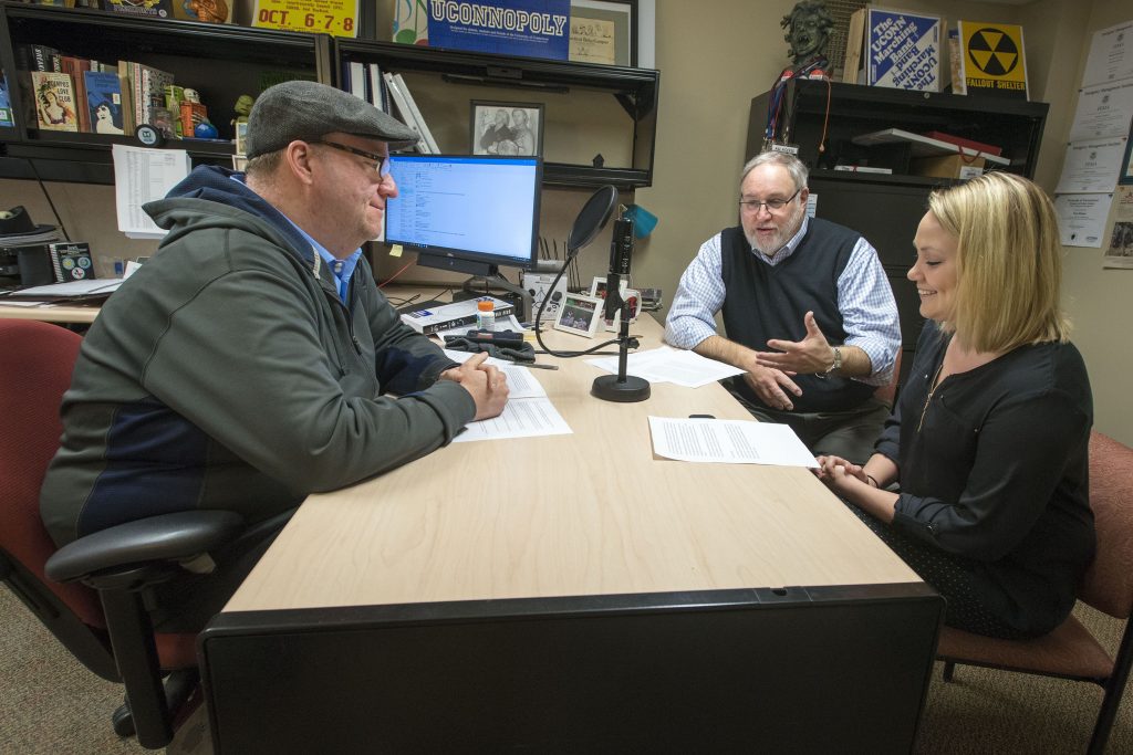 From left, Tom Breen ’00 (CLAS), Kenneth Best, and Julie (Stagis) Bartucca ’10 (BUS, CLAS), all of University Communications, taping a podcast at the Lakeside Building. (Sean Flynn/UConn Photo)