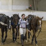 Julianna Gallo '20 (CAHNR), an animal science major, leads three polo ponies before the UConn Polo Match versus Kentucky on Feb. 3, 2018. (Garrett Spahn '18 (CLAS)/UConn Photo)
