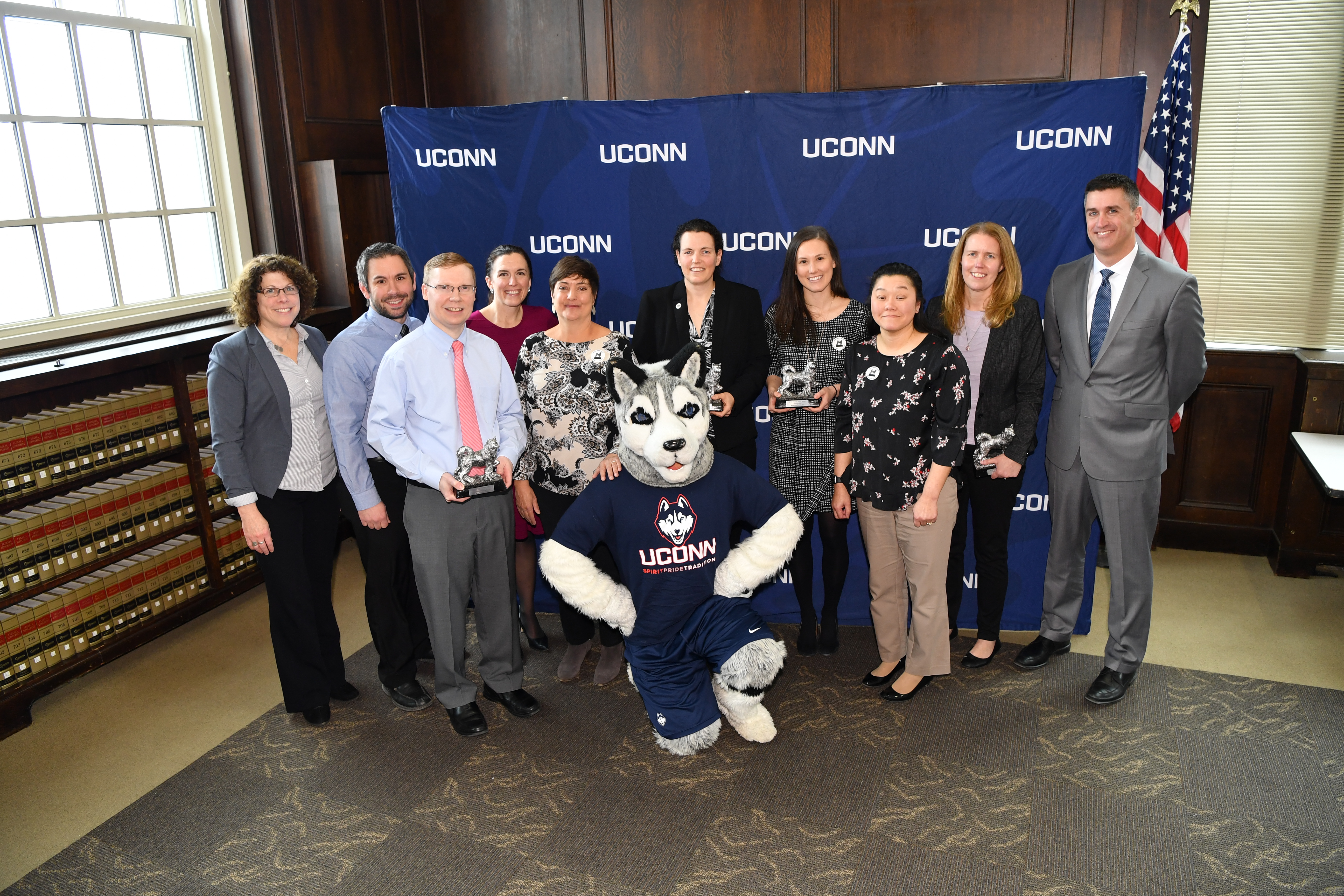 Winners of the 2018 Spirit Awards pose for a photo with Jonathan the Husky at Wilbur Cross, 2018. (Peter Morenus/UConn Photo)