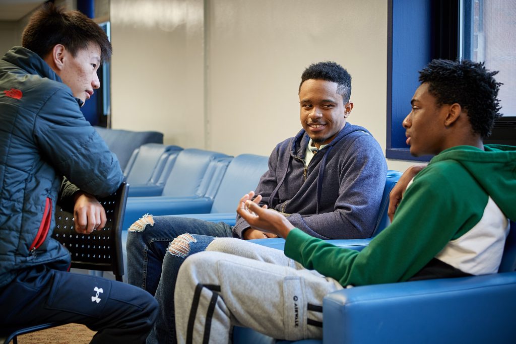 Norwyn Campbell '20 (ENG), center, with Rabjam Rabjam '21 (ENG), left, and Renaldo Lawson '21 (CLAS) in a lounge at Eddy Residence Hall. (Peter Morenus/UConn Photo)