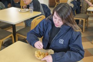 A student tucks into a bowl of chickpea rotini at Northwest Dining Hall. (Jeff Gonci/UConn Photo)