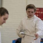 Glenn Thierfeldt '20 (ENG), a sophomore majoring in electrical engineering, checks out the point of his weapon during fencing practice on March 4. The blade has a pressure-sensitive button at its tip, and fencers wear clothing that is sensitive to the electrical weapon. (Garrett Spahn '18 (CLAS)/UConn Photo)