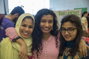 From left, Roushan Ahmed, a senior history major, Armana Islam, a freshman biology and women's, gender, and sexuality studies major, and Amrin Choudhury, a freshman accounting major, all members of the Bangladesh Students Association, at Worldfest. (Garrett Spahn '18 (CLAS)/UConn Photo)