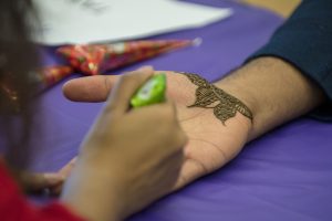 UConn Tarang, a group representing the South Asian graduate student community at UConn, gives henna tattoos at Worldfest. Tarang helps international students from India, Pakistan, Sri Lanka, Bangladesh, Nepal, Bhutan, and the Maldives to acclimate to UConn. (Garrett Spahn ’18 (CLAS)/UConn Photo)