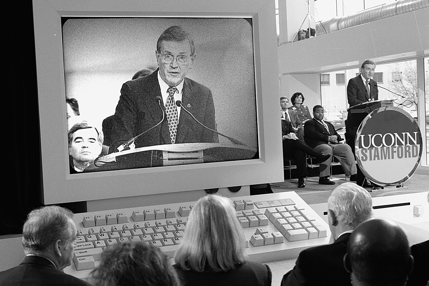 His image projected on a giant mockup computer, then-President Austin speaks at the Stamford campus dedication on April 17, 1998. (Peter Morenus/UConn File Photo).
