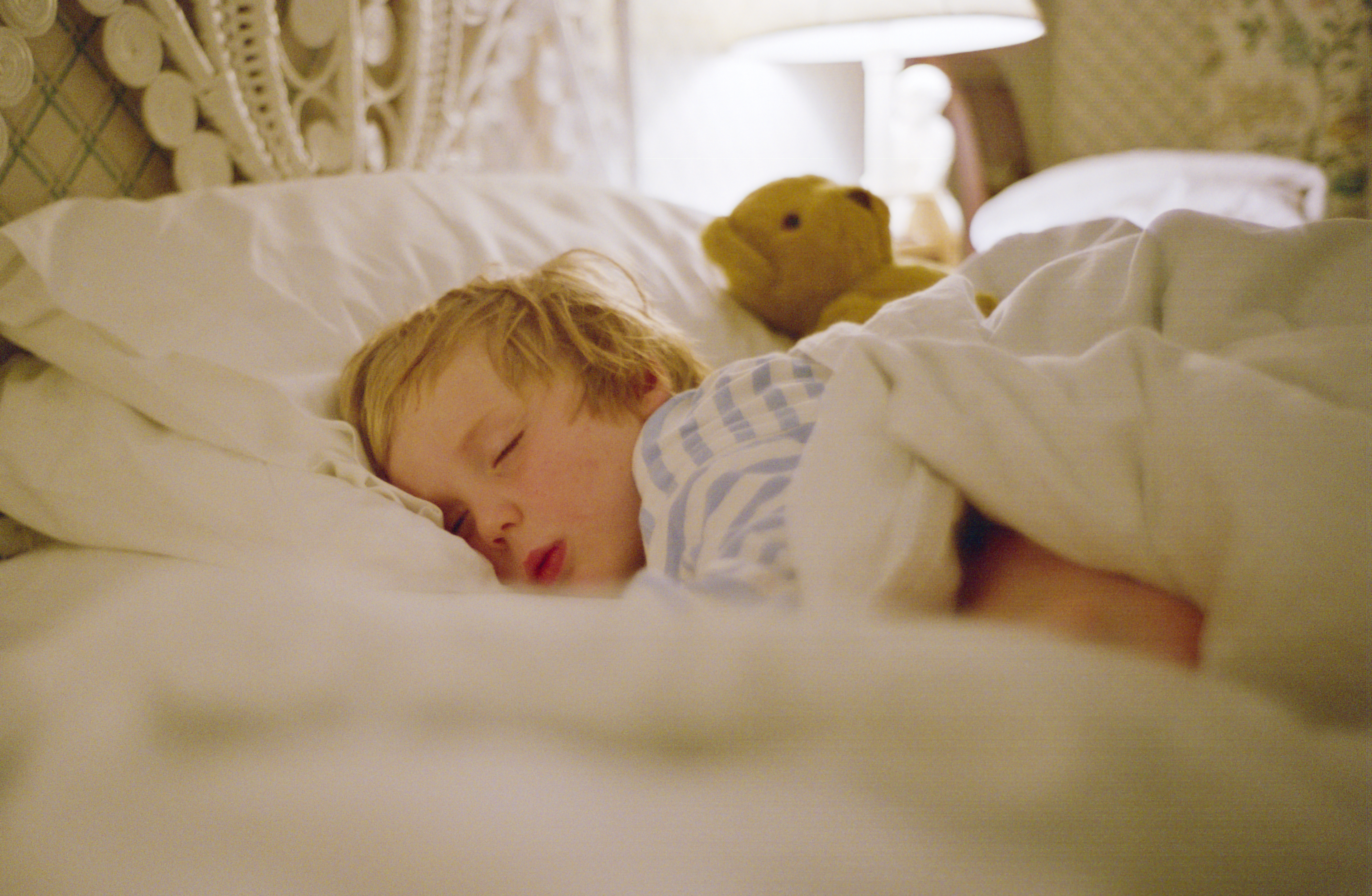 Young boy sleeping in a hotel bed. (Photo by Tim Graham/Getty Images)