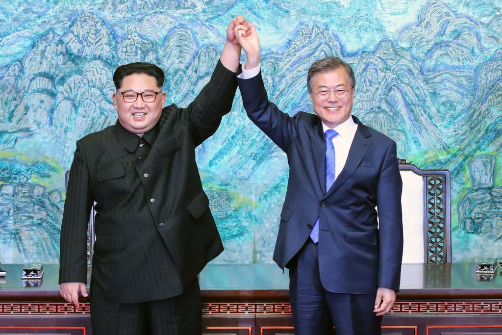 North Korean leader Kim Jong Un (L) and South Korean President Moon Jae-in (R) pose for photographs after signing the Panmunjom Declaration for Peace, Prosperity and Unification of the Korean Peninsula during the Inter-Korean Summit at the Peace House on April 27 in Panmunjom, South Korea. Kim and Moon meet at the border today for the third-ever Inter-Korean summit talks after the 1945 division of the peninsula, and first since 2007 between then President Roh Moo-hyun of South Korea and Leader Kim Jong-il of North Korea. (Photo by Korea Summit Press Pool/Getty Images)