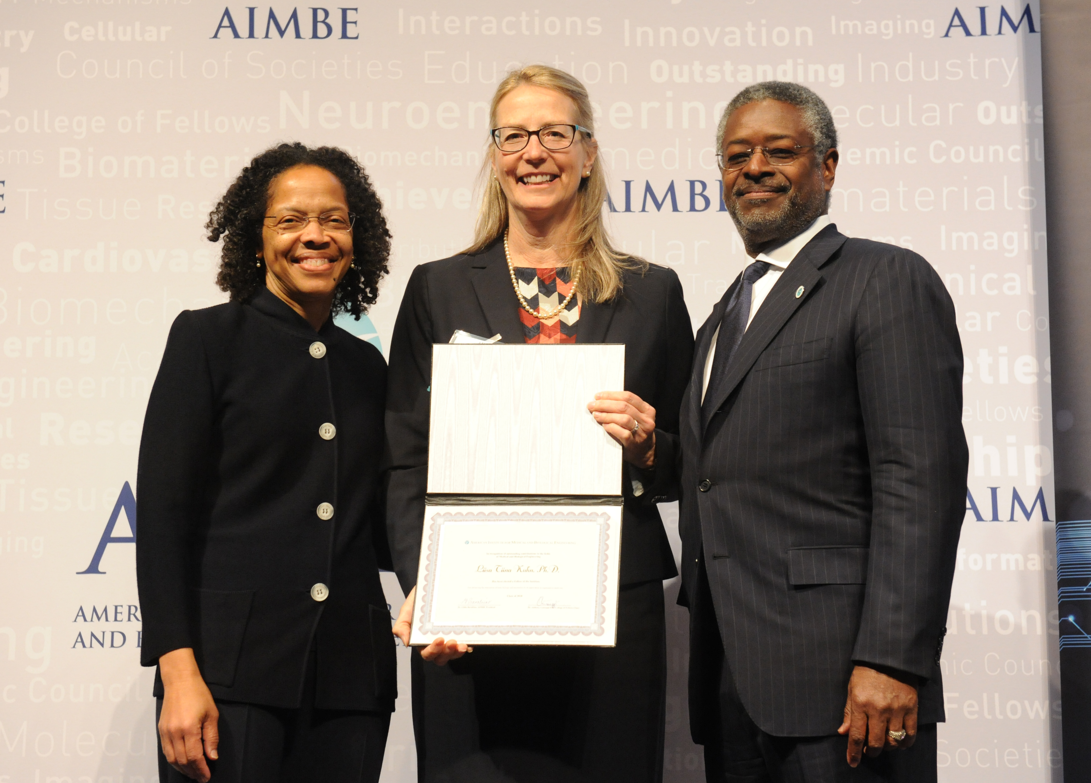 Liisa Kuhn, center, is inducted into the AIMBE Fellows National Academy of Sciences. She is joined by AIMBE President Gilda Barabino (left) and AIMBE Chair Anthony Guiseppi-Elie (right). (AIMBE Fellows Photo)