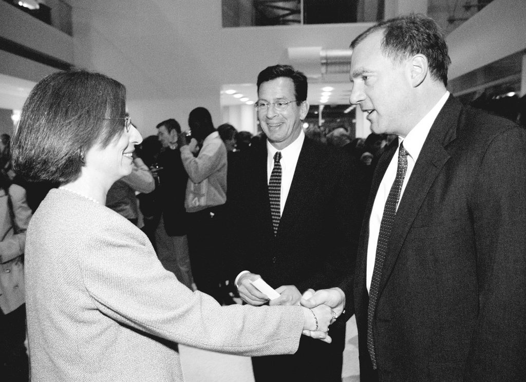 Jacquelyn Joseph-Silverstein, left, newly appointed director of the Stamford Campus, greets George Jepsen, right, a state senator, as Dannel Malloy, center, mayor of Stamford, looks on, at a reception at the Stamford Campus in 2002. (Peter Morenus/UConn File Photo)
