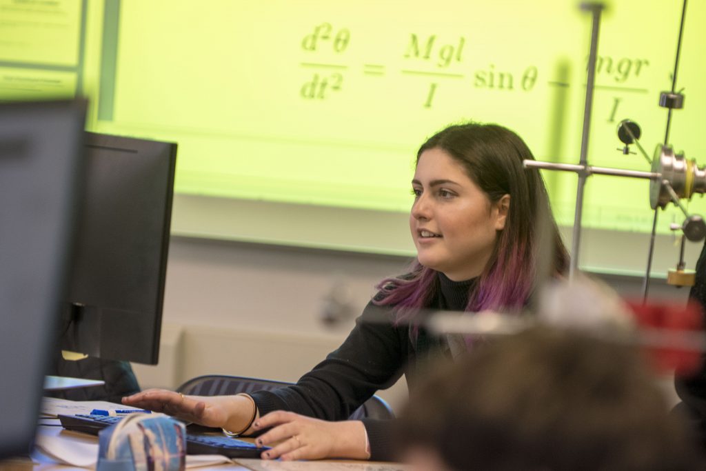 Undergraduate Anna Regan takes part in an introductory course for physics majors held in a newly renovated physics classroom where students are learning concepts through hands-on activities integrated into lectures. (Garrett Spahn '18 (CLAS)/UConn Photo)