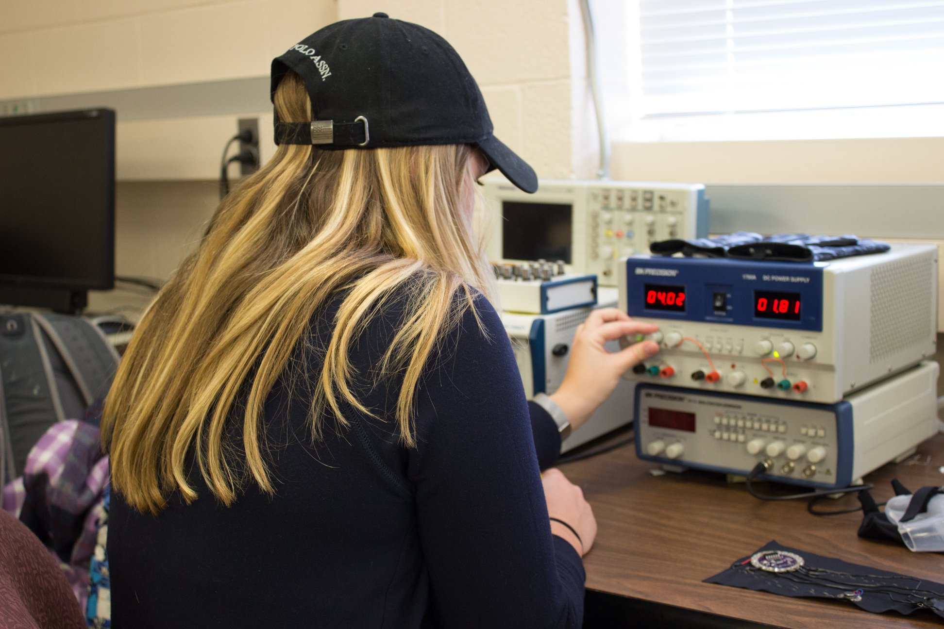 Katie Bradley '18 (BME) tests her device in the Arthur B. Bronwell Building (Eli Freund/UConn Photo)