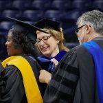 Kimberly Bryant, founder and executive director of Black Girls Code, left, who received an honorary Doctor of Science degree, is hooded by President Susan Herbst and Dean Kazem Kazerounian during the School of Engineering Commencement ceremony at Gampel Pavilion on May 5, 2018. (Peter Morenus/UConn Photo)