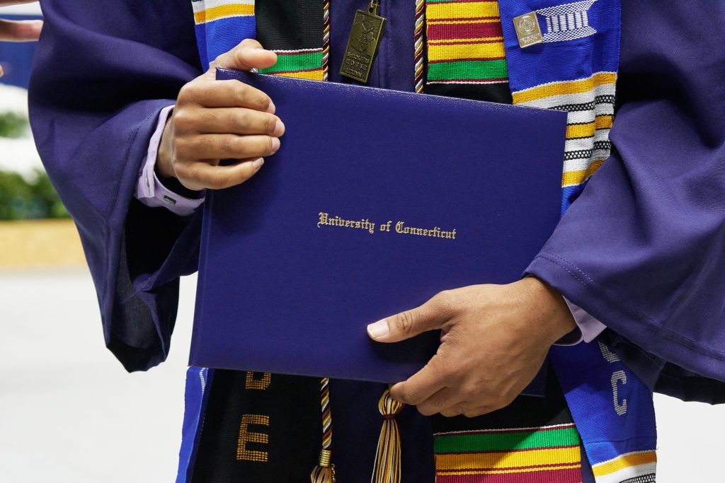 A degree candidate holds a diploma case during the School of Engineering Commencement ceremony at Gampel Pavilion on May 5, 2018. (Peter Morenus/UConn Photo)