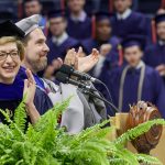President Susan Herbst, left, and Daniel Burkey, associate dean of engineering, clap following the conferral of degrees at the School of Engineering Commencement ceremony. (Peter Morenus/UConn Photo)