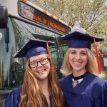 Courtney Dawless '18 (ENG), left, and Amanda Giroux '18 (ENG) pose for a photo with a UConn bus following the School of Engineering Commencement ceremony. (Peter Morenus/UConn Photo)