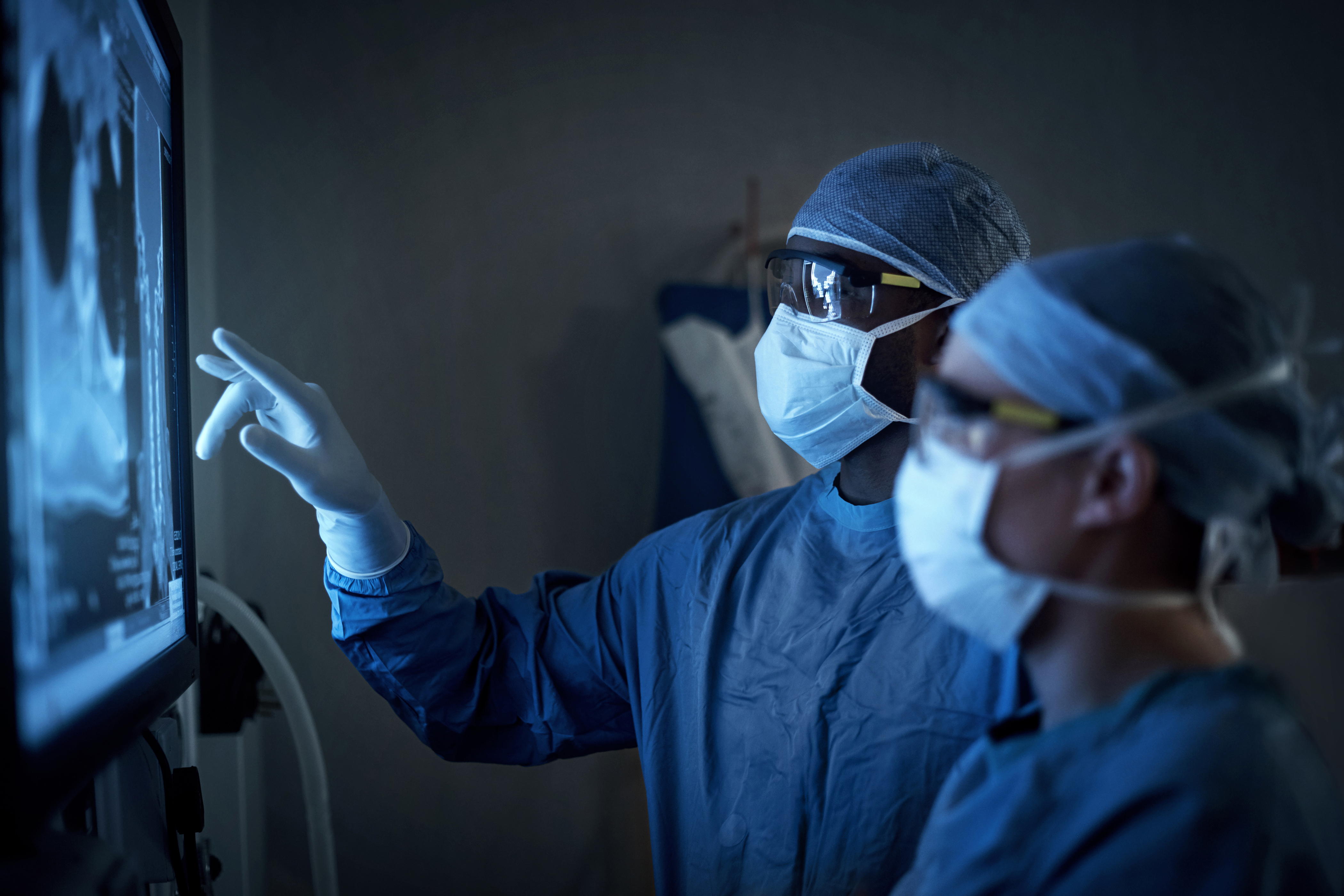 Shot of two surgeons analyzing a patient’s medical scans. (Getty Images)