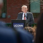 Larry McHugh, chairman emeritus of the Board of Trustees, speaks at the ceremony held on the Student Union Mall to name the former Laurel Hall in his honor. (Peter Morenus/UConn Photo)