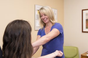 Pam Angelillo, R.N. caring for a patient at the ENT Department's clinical location at UConn Health's Outpatient Pavilion (Kristin Wallace/UConn Health Photo).