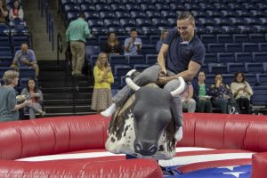 Vitaly Glybin of the Office of Institutional Research and Effectiveness rides the mechanical bull. (Sean Flynn/UConn Photo)