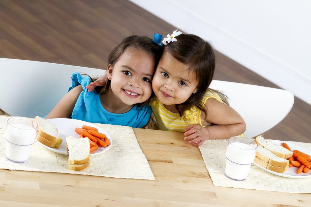 Two little girls eating lunch. (iStock Photo)