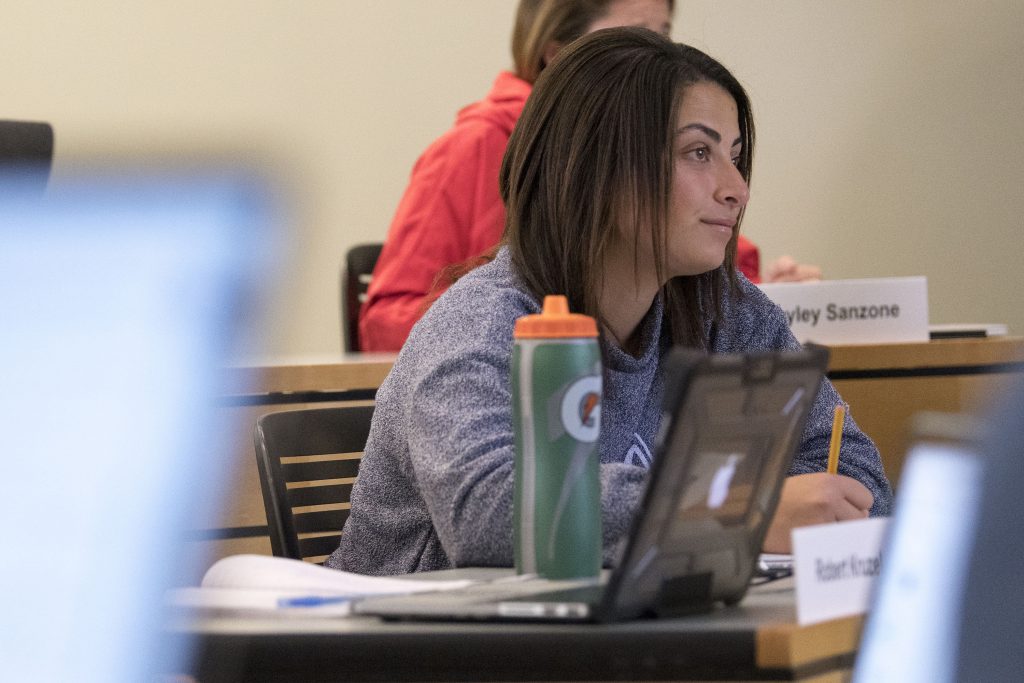 Student-athlete, Zaina Zaki ’18 (BUS) listens to a lecture on financial risk management by finance professor Shantaram Hegde in the School of Business. Zaki tried two different majors before settling on finance. (Sean Flynn/UConn Photo)