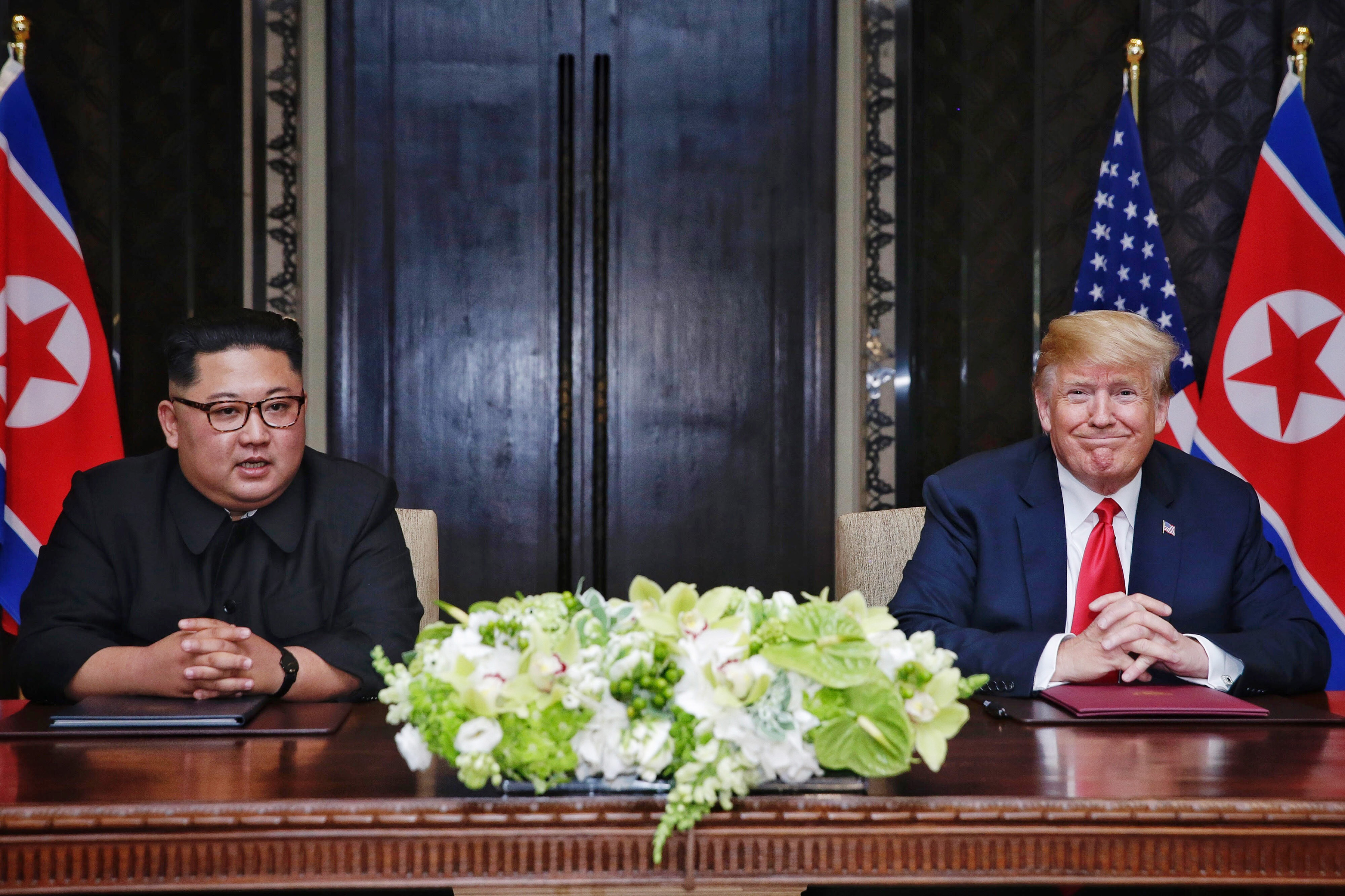 North Korean leader Kim Jong-un, left, with U.S. President Donald Trump during their historic summit in Singapore on June 12. (Kevin Lim/The Straits Times/Handout/Getty Images)