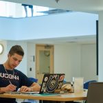 Michael Norell '18 (CLAS) studies at the UConn Hartford Library inside the Hartford Public Library on June 19, 2018. (Peter Morenus/UConn Photo)