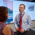 Michael Howser, right, director, speaks with librarian Marisol Ramos in the Digital Scholarship Studio at the UConn Hartford Library inside the Hartford Public Library on June 19, 2018. (Peter Morenus/UConn Photo)