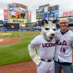 Dan Hurley, right, head coach of UConn Men's Basketball, poses for a photo with Jonathan the Husky before the New York Mets baseball game on June 3, 2018. (Peter Morenus/UConn Photo)