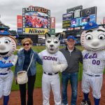 President Susan Herbst and her husband Doug Hughes pose for a photo with Mrs. Met, Jonathan the Husky, and Mr. Met before the New York Mets baseball game on June 3, 2018. (Peter Morenus/UConn Photo)