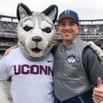 Richard Soares '97 (CLAS), '04 MBA, right, of Norwalk, with Jonathan the Husky at the New York Mets baseball game on June 3, 2018. (Peter Morenus/UConn Photo)