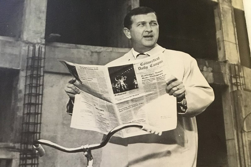 UConn President Homer Babbidge holds up a copy of the Daily Campus. It was one of the photos included in a picture essay titled 'The Odyssey of Homer' in the Nutmeg Yearbook of 1972, the year Babbidge stepped down. (Nutmeg Yearbook Photo)