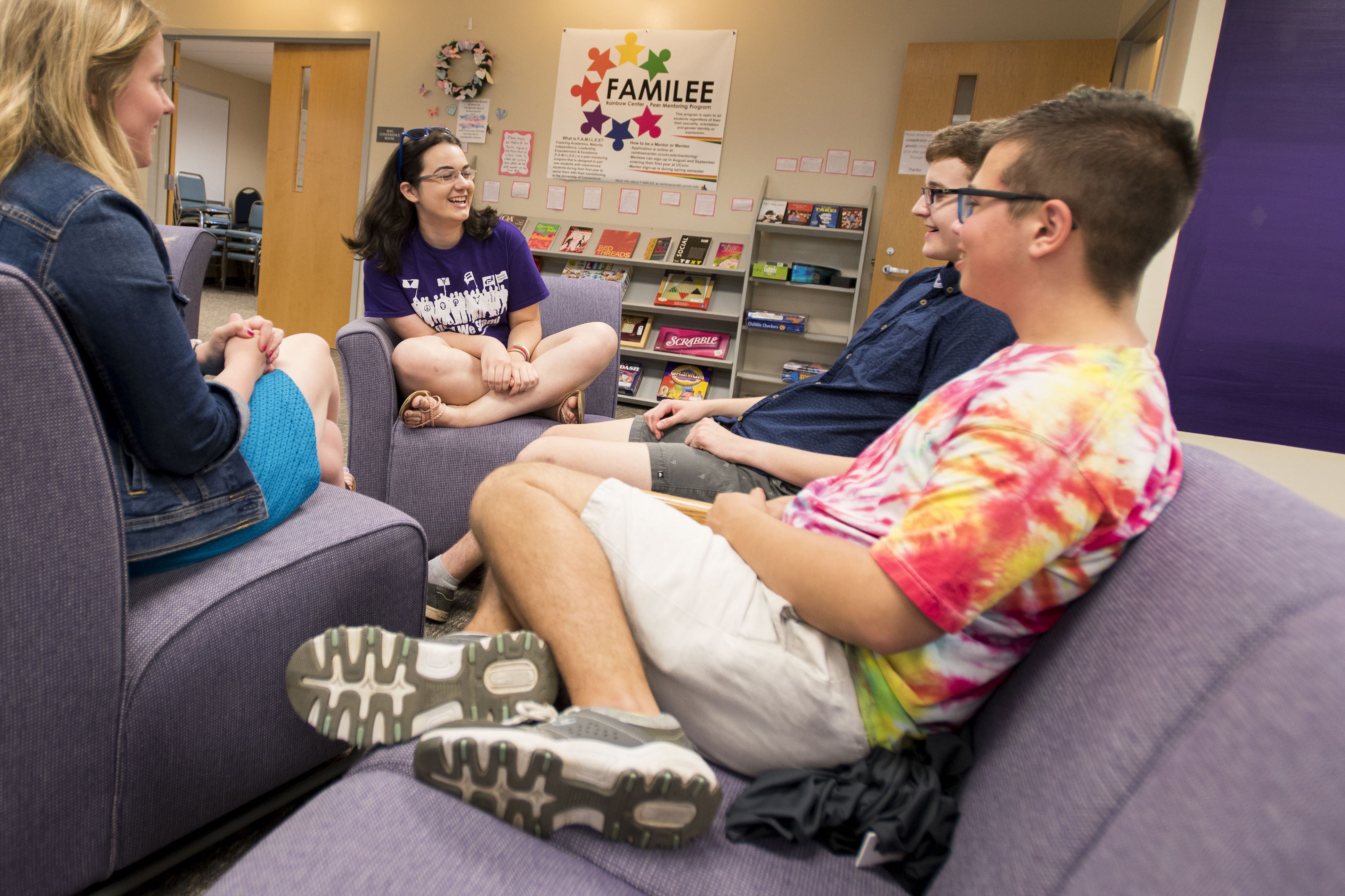 Clockwise from left, program coordinator Julia Anderson ’18 MA has a conversation with Anastasia Martineau ’20 (CLAS), Emmett Santisi ’21 (ENG), and Zane Carey ’18 (CLAS) at the Rainbow Center on June 18, 2018. (Sean Flynn/UConn Photo)