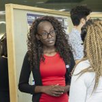 Venoude Valmyr, a biomedical engineering major in the School of Engineering with a minor in anthropology, speaks about her research at the McNair Scholars Poster Session on July 25, 2018. (Christine Buckley/UConn Photo)