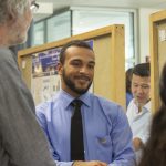 Raphael Britt, a molecular and cell biology major in the College of Liberal Arts and Sciences, speaks about his research at the McNair Scholars Poster Session on July 25, 2018. (Christine Buckley/UConn Photo)