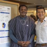 Richmond Apore '19 (CLAS), a biological sciences major, with research mentor Alfredo Angeles-Boza, assistant professor of chemistry, at the McNair Scholars Poster Session on July 25, 2018. (Christine Buckley/UConn Photo)