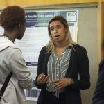 Sarah Beckett Cleveland '19 (CLAS), a biological sciences major, speaks about her research at the McNair Scholars Poster Session on July 25, 2018. (Christine Buckley/UConn Photo)