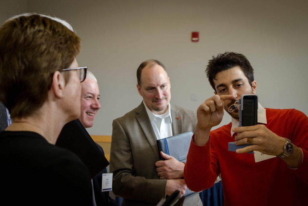 Reza Amin, co-founder of QRfertile LLC and UConn Ph.D candidate in Mechanical Engineering, shows a panel of judges his technology at a competition in 2016 (Christopher LaRosa/UConn Photo)