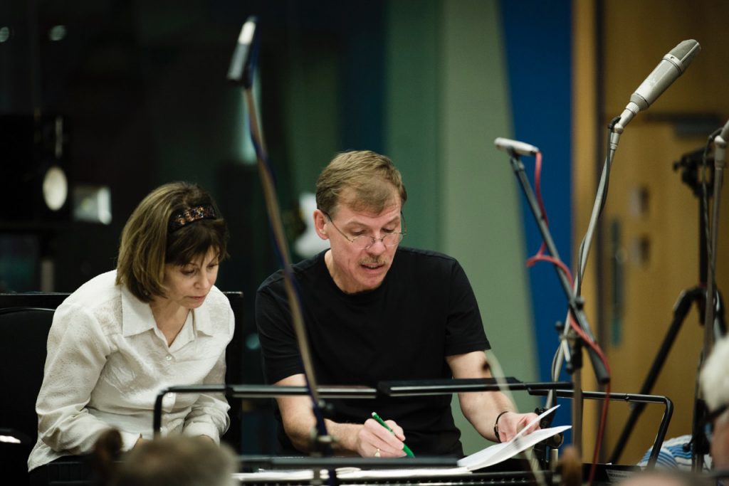 Kenneth Fuchs confers with conductor Joanne Falletta during a recording session with the London Symphony Orchestra in the Abbey Road Studios.