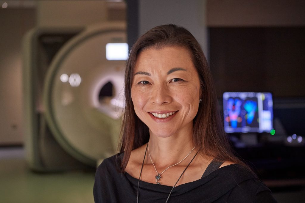 Fumiko Hoeft stands near the fMRI at the Brain Imaging Resource Center on Aug. 1, 2018. (Peter Morenus/UConn Photo)