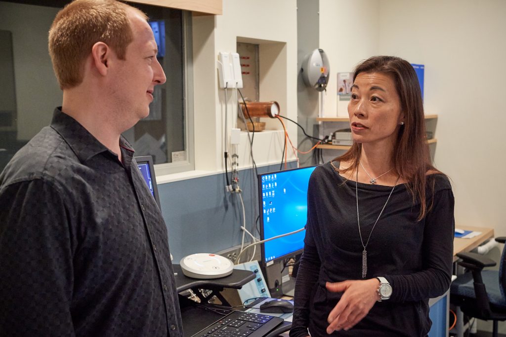 Fumiko Hoeft speaks with Roeland Hancock at the Brain Imaging Resource Center on Aug. 1, 2018. (Peter Morenus/UConn Photo)