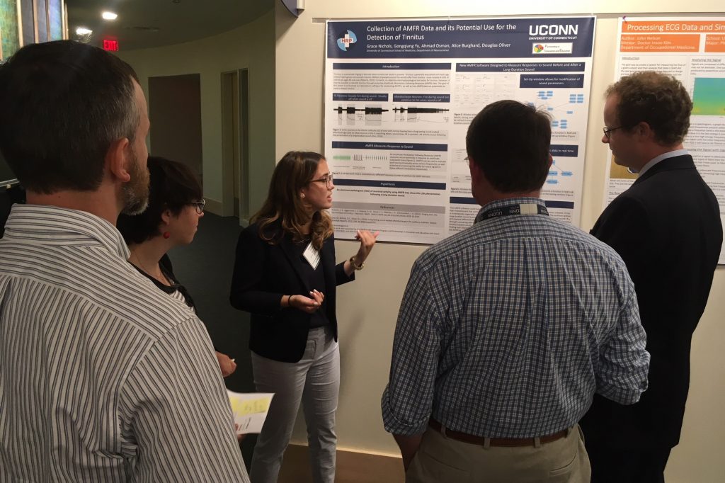 PIE Fellow Grace Nichols, a molecular and cell biology major at UConn, presents her research at the poster session. Her faculty mentor is Douglas Oliver in Department of Neuroscience at UConn Health. (Lauren Woods/UConn Health Photo)