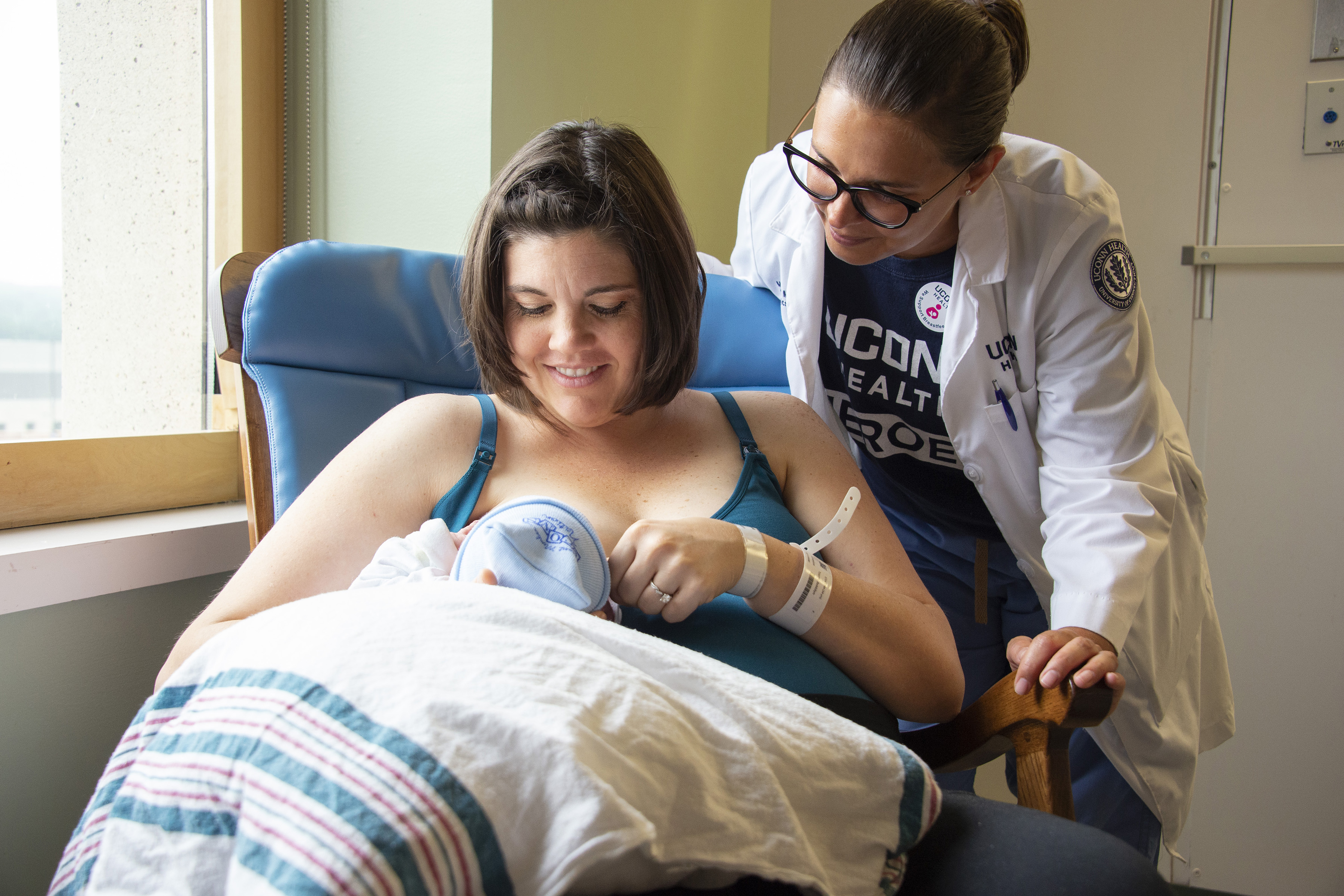 Lactation consultant Marisa Merlo helps maternity patient Bekkilyn Toone breastfeed her newborn son in UConn Health's labor and delivery unit. (Kristin Wallace/UConn Health Photo)