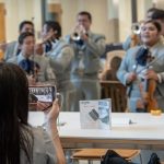Students take photos of the Mariachi Mexico Antiguo Band during the Hartford Campus Convocation. (Sean Flynn/UConn Photo)
