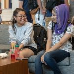 April Saynganthone ’21 (CLAS), left, and Lubna Rauf ’21 (CLAS) chat during the Hartford Campus Convocation celebration in the Zachs Atrium on Aug. 29, 2018. (Sean Flynn/UConn Photo)