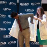 On Aug. 24, the entering class at the School of Medicine received their white coats during the annual White Coat Ceremony. The white coat has become a symbol of the science and art of medicine. The Class of 2022 is the School's 50th class, and also its largest at 106 students. (Tina Encarnacion/UConn Health Photo)