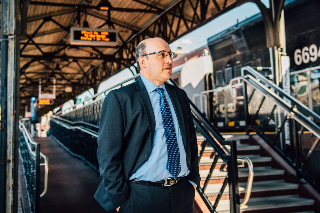 Professor Jeff Cohen , pictured above, at Union Station in Hartford, is studying the impact that a new passenger rail line will have on residential and commercial development. The train, which travels from New Haven to Springfield, Mass., with many stops in between, began service in June. (Nathan Oldham/UConn School of Business)